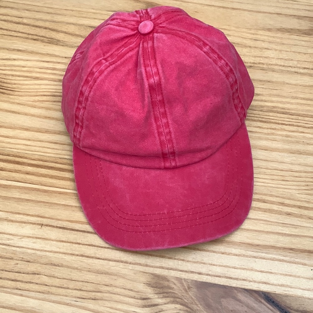 Jenni red cap. Adjustable and never worn. Excellent condition.